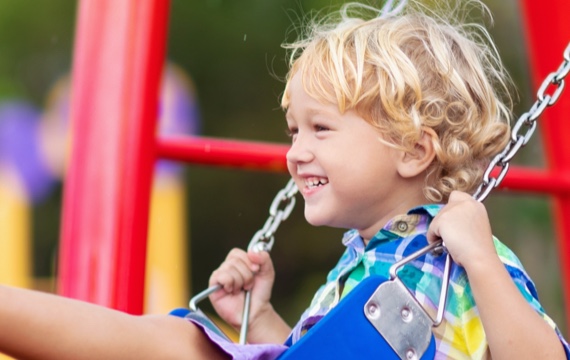 A young child on a swing.