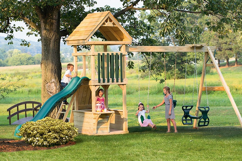 Children playing on a wooden playset.